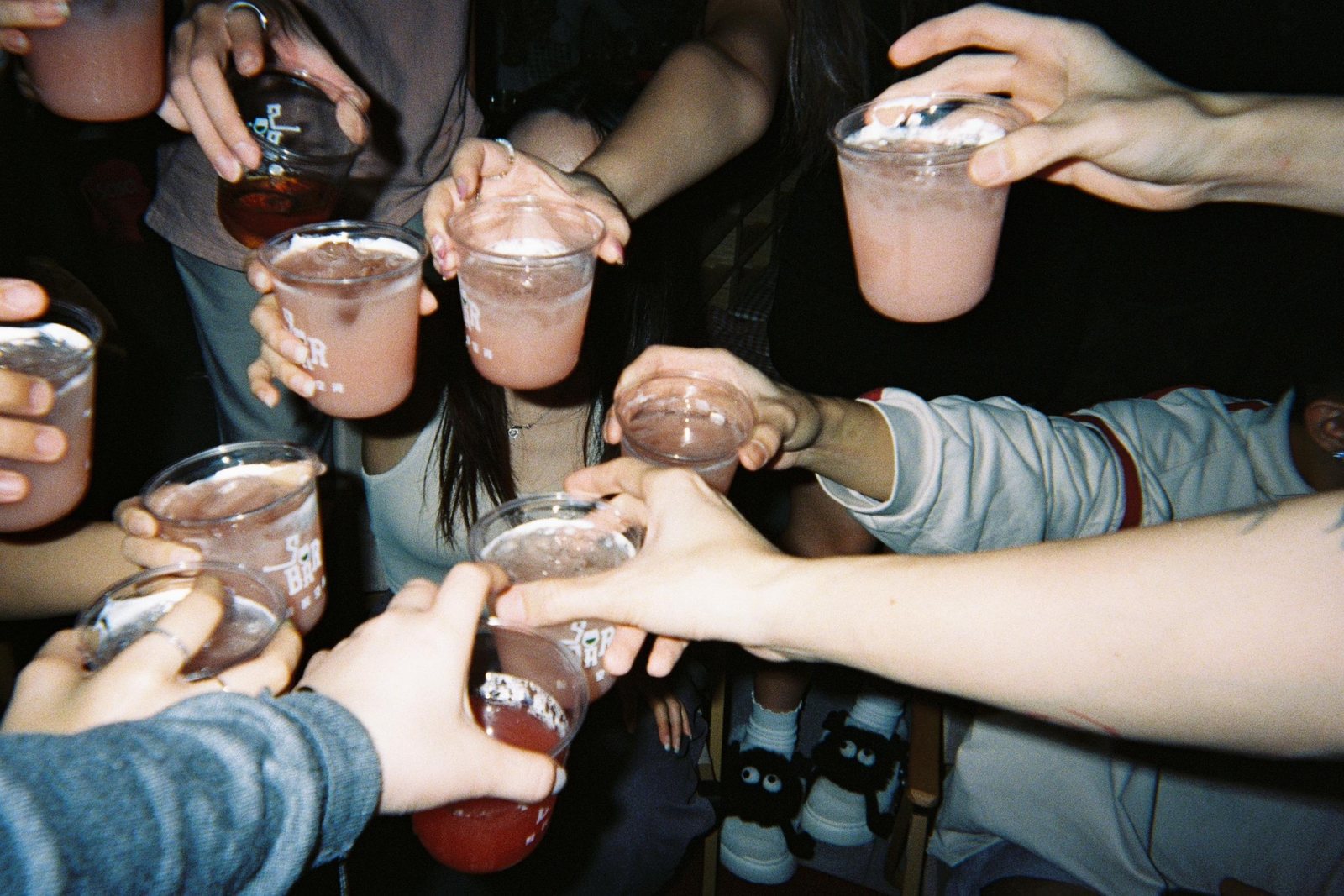 Group cheers with pink drinks at So Bar