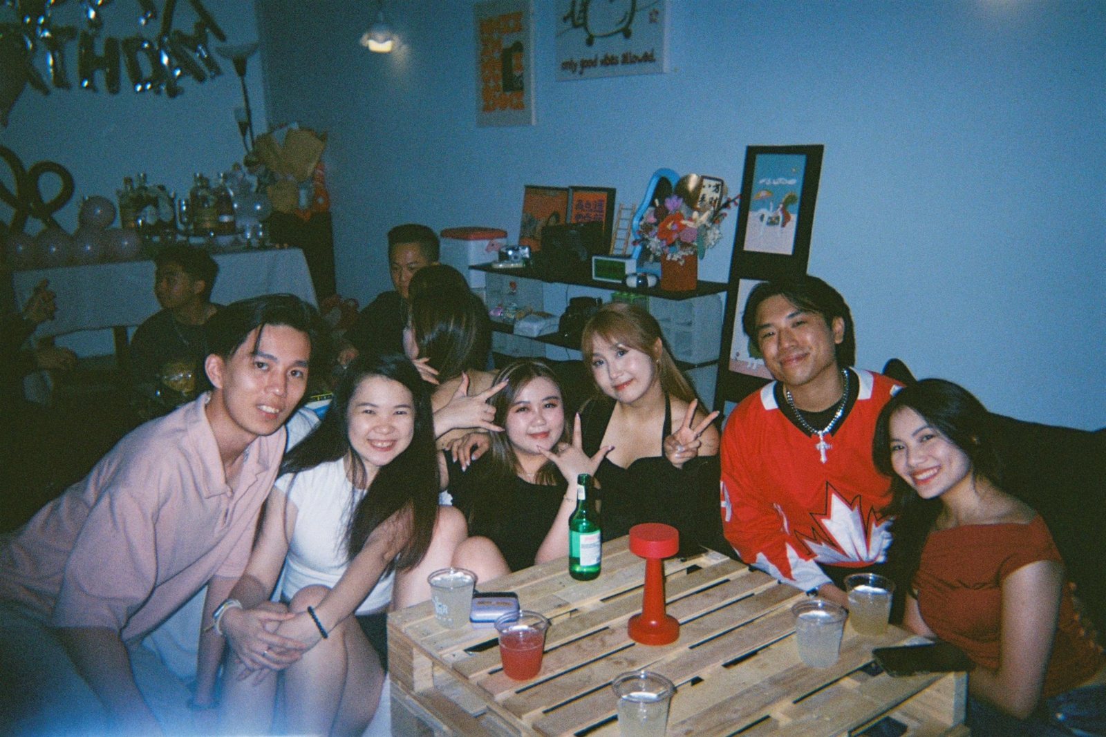 Small group of friends seated around a table in So Bar