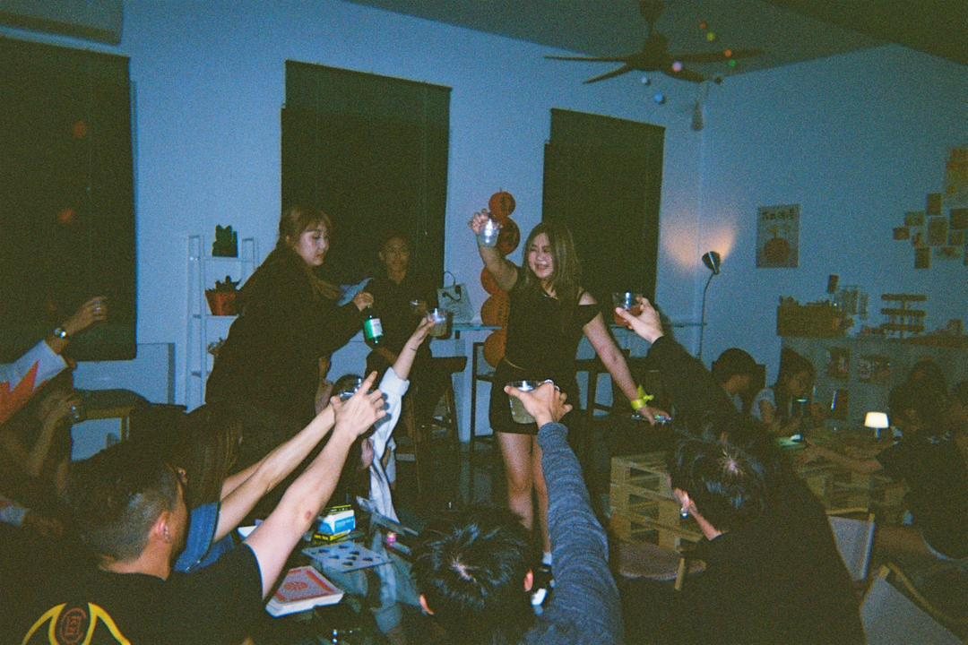 Guests raising drinks inside So Bar